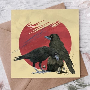 May include: Square art print depicting two black crows with blue beaks, set against a yellow backdrop with a red circle and abstract brushstrokes. The crows are near mushrooms. The print is inside a brown envelope.