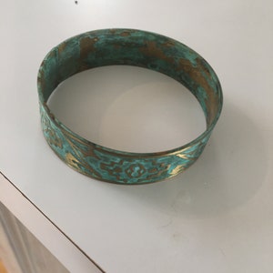 Brass bangle bracelet with Indian symbols