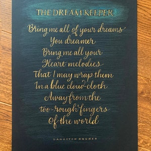 May include: A black background with gold lettering that reads "THE DREAM KEEPER" and a poem by Langston Hughes: "Bring me all of your dreams You dreamer Bring me all your Heart melodies That I may wrap them In a blue cloud-cloth Away from the too-rough fingers of the world."