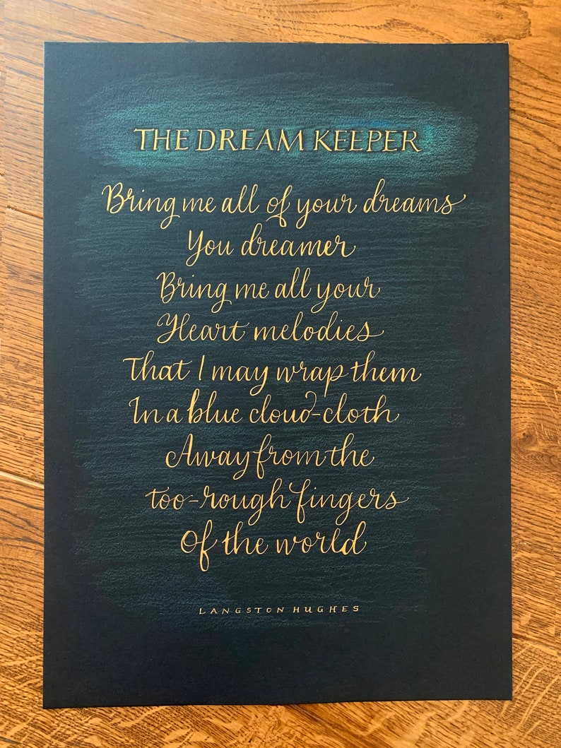 May include: A black background with gold lettering that reads "THE DREAM KEEPER" and a poem by Langston Hughes: "Bring me all of your dreams You dreamer Bring me all your Heart melodies That I may wrap them In a blue cloud-cloth Away from the too-rough fingers of the world."