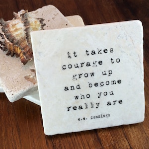 May include: White ceramic coaster with the quote "it takes courage to grow up and become who you really are - e.e. cummings" printed in black.