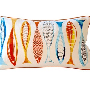 May include: Rectangular decorative pillow with a white background and a pattern of stylized fish in shades of blue, orange, and yellow. The pillow has a brown border.