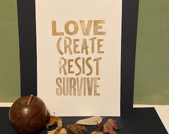 Inspiring quote: letterpress print. Love create resist survive.