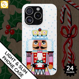 Custodia per telefono Schiaccianoci illustrata bianca e blu, atmosfera natalizia colorata, Natale giocoso, arte popolare natalizia invernale carina, guscio rigido sottile
