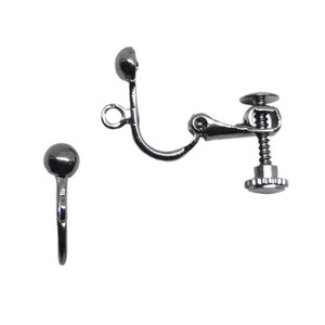 May include: Two silver-toned clip-on earrings. One earring has a small ball at the top and a curved clip. The other earring has a ball, a curved arm, and a screw-adjustable clip. The earrings are set against a white background.
