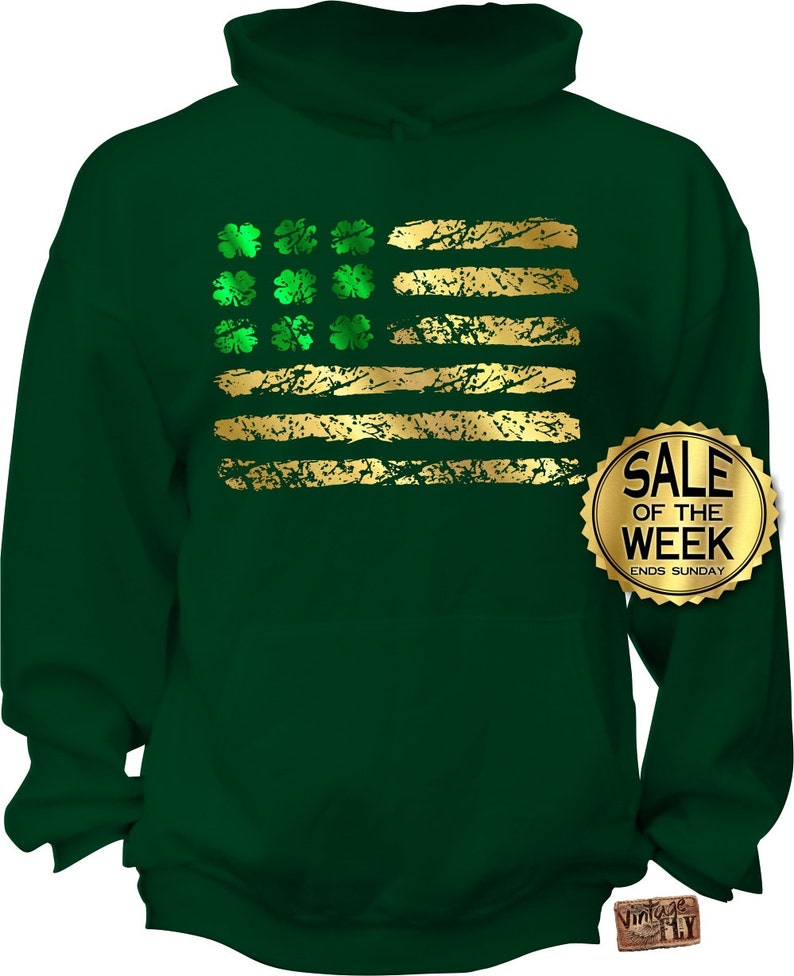 May include: Green hoodie featuring a distressed gold and green shamrock and stripe design. The design resembles a flag. A gold sticker on the right side says "SALE OF THE WEEK ENDS SUNDAY".