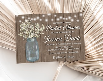 May include: Rustic wood background with a mason jar filled with white baby's breath flowers. The text "PLEASE JOIN US FOR A BRIDAL SHOWER IN HONOR OF BRIDE-TO-BE Jessica Davis SATURDAY OCTOBER 15TH | 3:00 PM THE WEST SIDE INN 8567 NORTH MAIN ST. MAINVILLE RSVP TO JENNIFER AT 254-230-6987 Registered at Amazon" is printed on the invitation.