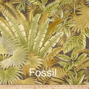May include: A close-up of a fabric with a tropical leaf pattern in shades of green, brown, and yellow. The fabric has the word "Fossil" printed on it.