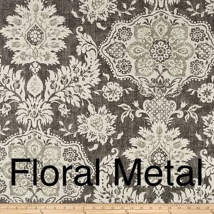 May include: Close-up of a fabric with a repeating floral pattern in shades of gray and off-white. The words "Floral Metal" are printed across the bottom of the fabric. The fabric has a textured appearance.