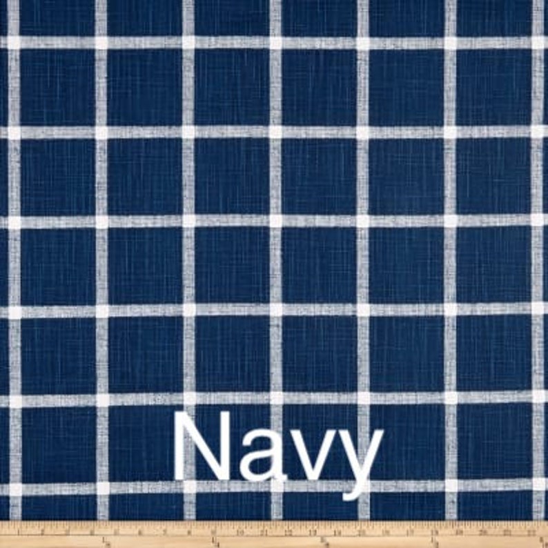 May include: Navy blue fabric with a white checkered pattern. The fabric has a textured surface.