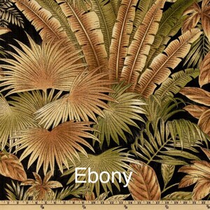 May include: A close-up of a fabric with a tropical leaf pattern in shades of brown, green, and black. The fabric has the word "Ebony" printed on it.