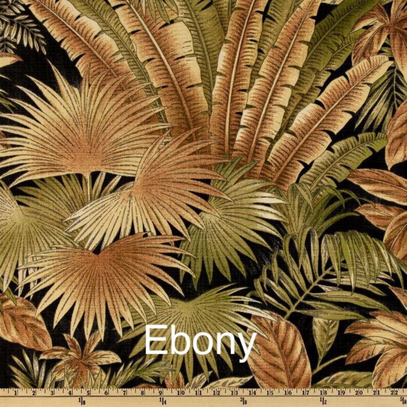 May include: A close-up of a fabric with a tropical leaf pattern in shades of brown, green, and black. The fabric has the word "Ebony" printed on it.
