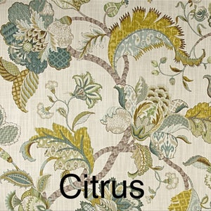 May include: A floral fabric with a white background and a repeating pattern of green, brown, and blue flowers. The fabric has a textured look and the word "Citrus" is printed in black at the bottom of the image.
