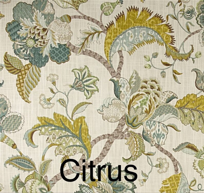 May include: A floral fabric with a white background and a repeating pattern of green, brown, and blue flowers. The fabric has a textured look and the word "Citrus" is printed in black at the bottom of the image.