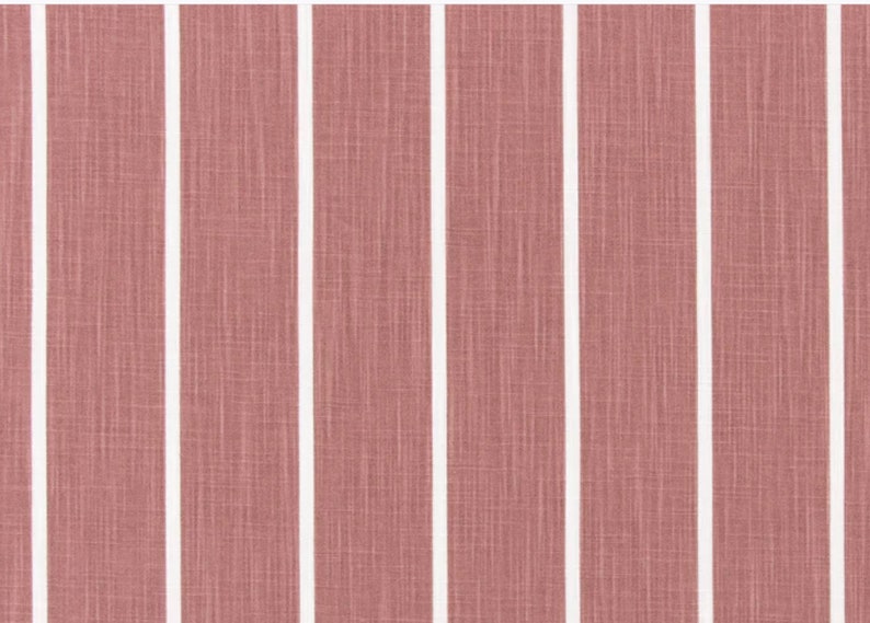 May include: A close-up of a pink and white striped fabric with a subtle textured pattern.