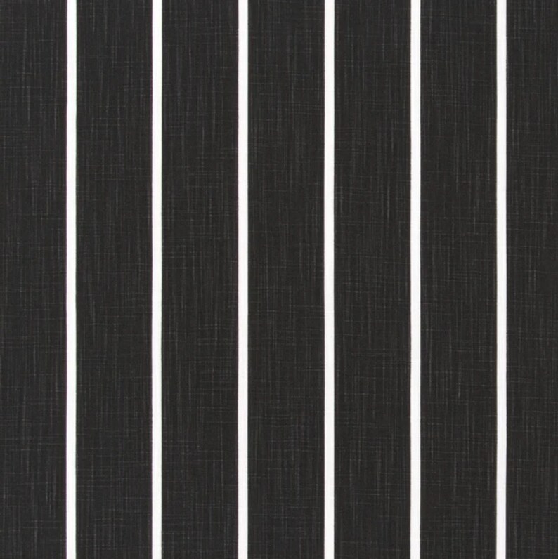 May include: Black and white striped fabric with a subtle textured pattern. The fabric has a vertical striped design with white stripes against a black background.