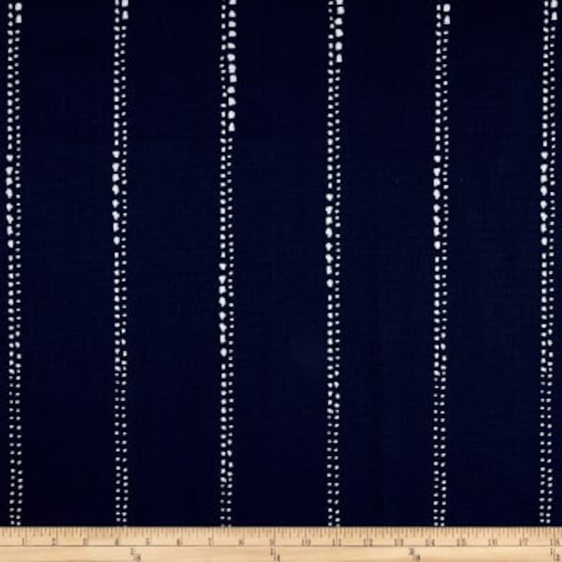 May include: Navy blue fabric with white dotted lines running vertically. The fabric has a subtle texture.