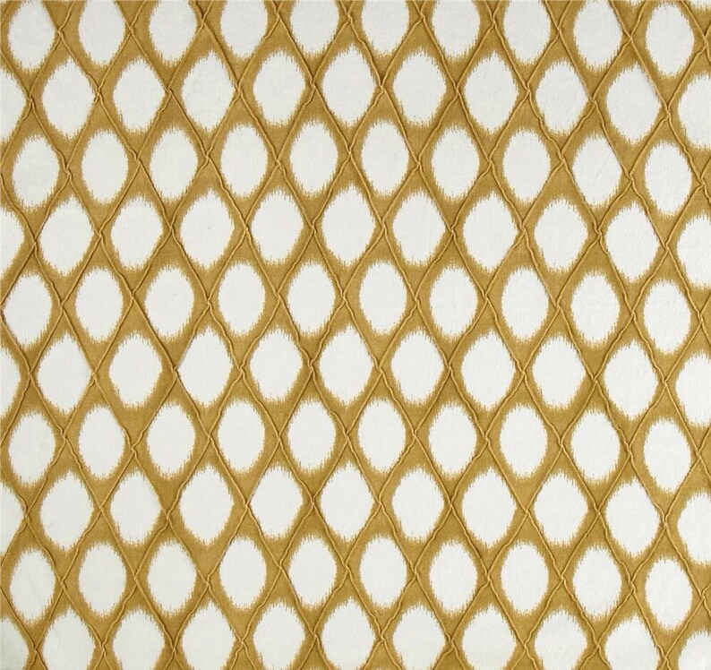May include: A white and gold fabric with a repeating pattern of white circles surrounded by a gold diamond shape.