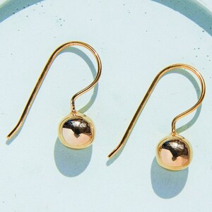 Puff ball earrings outlet