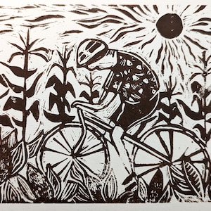 May include: A black and white linocut print of a person riding a bicycle through a field of tall grass. The sun is shining brightly in the sky.