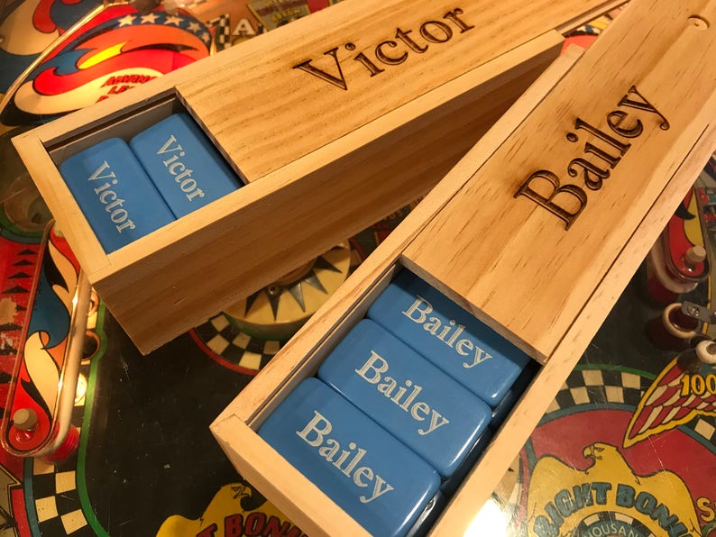 May include: Two wooden boxes with blue tiles inside. The boxes are personalized with the names "Victor" and "Bailey".
