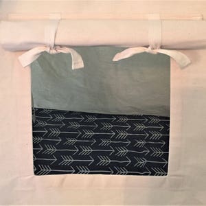 May include: A white canvas tent with a roll-up window. The window is open and shows a black and white fabric with a pattern of arrows.