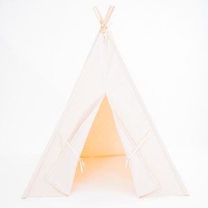May include: A white canvas teepee tent with wooden poles. The tent is open and the interior is visible.
