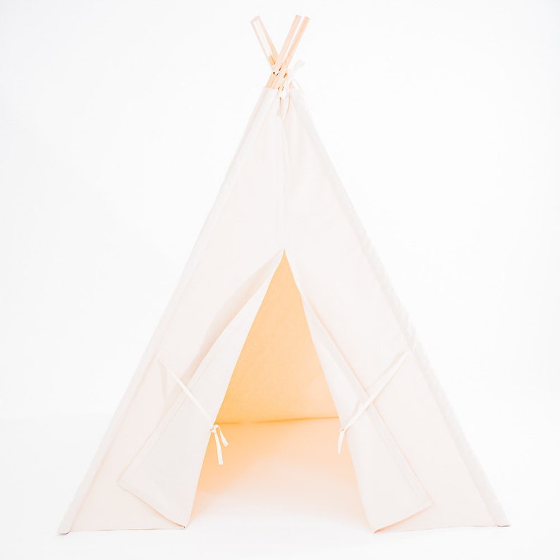 May include: A white canvas teepee tent with wooden poles. The tent is open and the interior is visible.