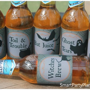 May include: Several bottles of amber-colored liquid with Halloween-themed labels. The labels feature spooky names like "Spider Venom," "Bat Juice," and "Ghost Tears." One bottle lies horizontally, labeled "Witches Brew."