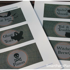 May include: Halloween-themed beer labels with spooky illustrations. Designs include "Bat Juice," "Ghost Tears," "Poison," "Spider Venom," "Toil & Trouble," and "Witches Brew." Each label features a unique graphic and text.