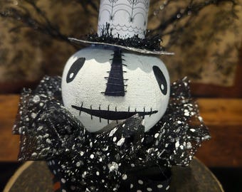 Hex, is our primitive Halloween skeleton head sitting on a paper mache box.