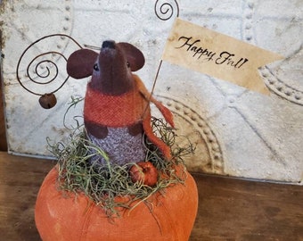 Cheddar, our primitive wool felt fall mouse sitting on a prim pumpkin