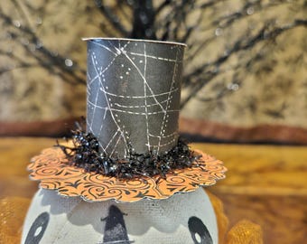 Hex, is our primitive Halloween skeleton head sitting on a paper mache box.