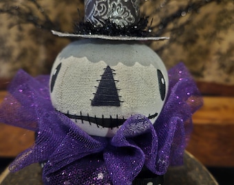 Hex, is our primitive Halloween skeleton head sitting on a paper mache box.