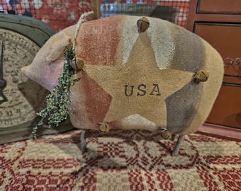 Hamilton our primitive self standing americana pig saying USA on his belly