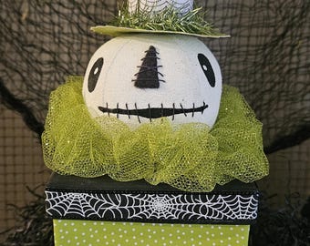 Hex, is our primitive Halloween skeleton head sitting on a paper mache box