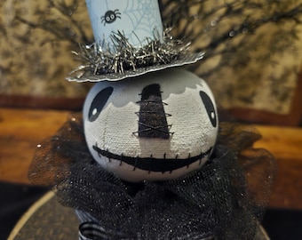 Hex, is our primitive Halloween skeleton head sitting on a paper mache box.