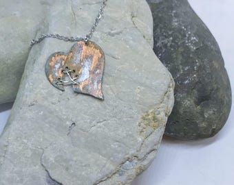 Copper patina stitched heart pendant