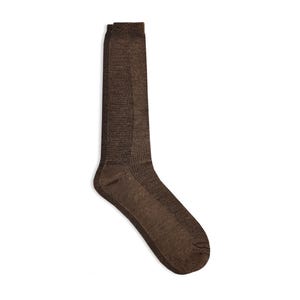 May include: A pair of brown socks, made of a textured knit fabric. The socks are knee-high with a ribbed cuff and a reinforced heel and toe. The socks are designed for comfort and warmth.