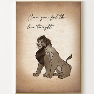 May include: A framed print featuring a lion and lioness in a loving embrace, set against a sepia-toned background. The text "Can you feel the love tonight" is written in elegant script above the illustration. The artwork is enclosed in a gold frame.