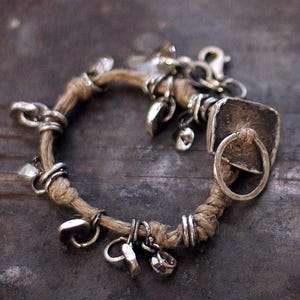 Rustic boho bracelet in natural light, showing the organic combination of linen cord, recycled silver, and Swarovski crystals. Handcrafted slowly with care, this artisan bracelet reflects earthy elegance and quiet luxury. Perfect for minimal, nature-inspired fashion — wearable art that feels soulful, tactile, and timeless.