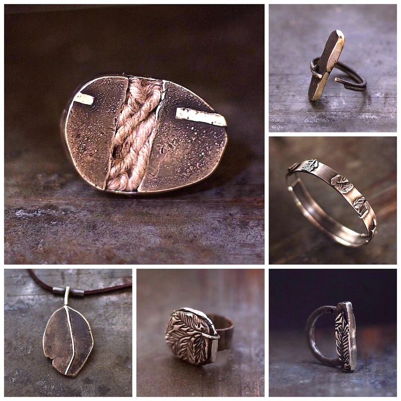 May include: A collection of handcrafted jewellery pieces. Features an oval pendant with a woven centre, a pendant necklace, and several rings with unique designs. The jewellery is made of metal with a rustic, textured finish.