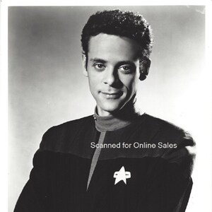 May include: Black and white photo of Alexander Siddig as Dr. Julian Bashir from the TV show "Star Trek: Deep Space Nine".