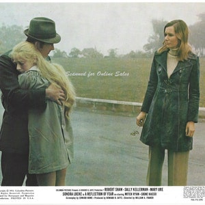 May include: A scene from the movie "A Reflection of Fear" starring Sondra Locke, Robert Shaw, and Sally Kellerman. The image shows Sondra Locke being hugged by Robert Shaw, while Sally Kellerman looks on.