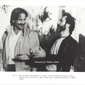 May include: A black and white promotional photograph featuring two men, Don Johnson and Robert F. Lyons, in casual attire. The text at the bottom reads: CF 9 - Don Johnson and Robert F. Lyons, both unemployed Vietnam vets, become fast friends as they share their common problems in CEASE FIRE.