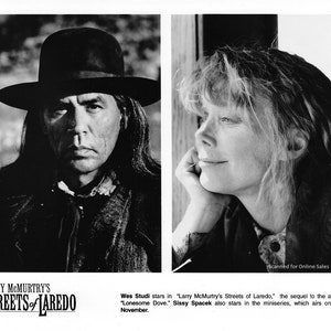 May include: Black and white photo of two actors, Wes Studi and Sissy Spacek, from the miniseries "Larry McMurtry's Streets of Laredo".
