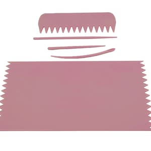 May include: A set of pink plastic cake decorating tools. The set includes a comb, a straight edge, and a curved edge.