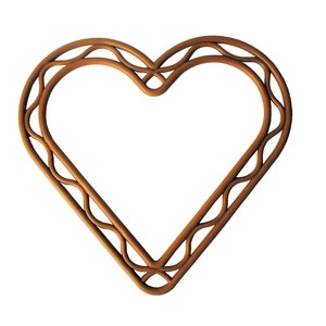 May include: A brown wooden heart-shaped frame with a decorative, intricate design. The frame is made of interwoven pieces of wood, creating a unique and elegant look.