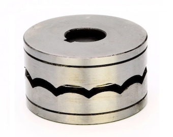 May include: A silver metal roller with a wavy edge and a center hole. The roller is used for creating decorative edges on metal.