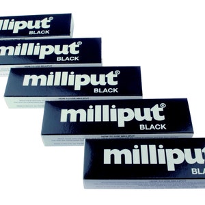 May include: Five tubes of black Milliput epoxy putty. The tubes are stacked on top of each other, with the largest tube at the bottom and the smallest tube at the top. Each tube has the word "Milliput" printed in white on a black background, with the word "Black" printed below it.